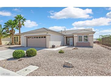 Charming single-story home with desert landscaping, palm trees, and a two-car garage at 1735 Black Fox Canyon Rd, Henderson, NV 89052