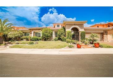 Beautiful single-story home with a well-manicured lawn and desert landscaping at 213 Villa Borghese St, Las Vegas, NV 89138
