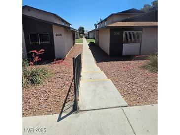 Apartment exterior showcasing building numbers and walkway under a sunny sky at 236 N Bruce St # C, Las Vegas, NV 89101