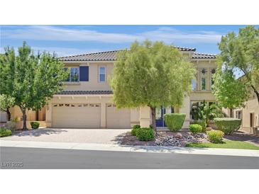 Inviting two-story home featuring a three-car garage, a well-manicured yard, and a tiled roof at 2753 Kildrummie St, Henderson, NV 89044