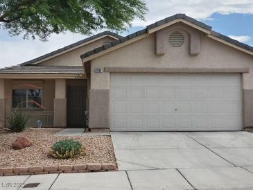 Charming single-story home featuring a two-car garage, desert landscaping, and a neutral color palette at 7801 Olympus Ave, Las Vegas, NV 89131