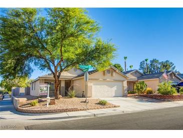 Charming single story home with a two car garage, desert landscaping, and a spacious driveway at 7801 Olympus Ave, Las Vegas, NV 89131