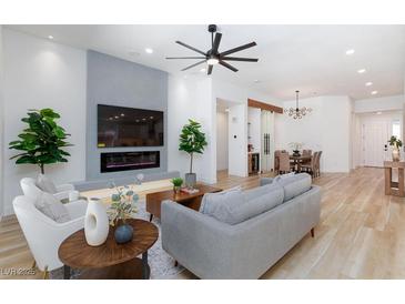 Bright living room with sleek fireplace, large TV, modern ceiling fan, and stylish, contemporary decor at 81 Alerion St, Las Vegas, NV 89138