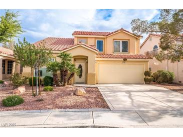 Two-story home with desert landscaping, an attached two-car garage, and a red tile roof at 1742 Ashburn Dr, North Las Vegas, NV 89032