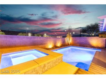 Beautiful pool and spa with brick surround under a stunning night sky at 2832 Aragon Terrace Way, Henderson, NV 89044