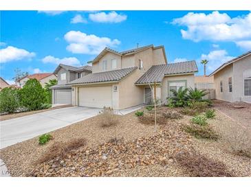 Charming two-story home featuring desert landscaping, a tile roof, and an attached two-car garage at 3659 Gerri Bay Ln, Las Vegas, NV 89147