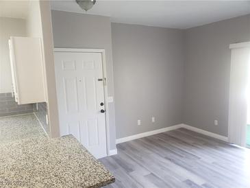 Bright living room featuring new gray flooring and neutral wall color at 5655 E Sahara Ave # 2068, Las Vegas, NV 89142