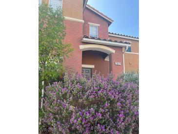 Inviting front exterior showcasing desert landscaping and warm, inviting curb appeal at 7977 Delft Blue St, Las Vegas, NV 89139