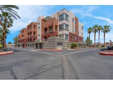 Attractive multi-story condo building with balconies and desert landscaping at 87 E Agate Ave # 403, Las Vegas, NV 89123
