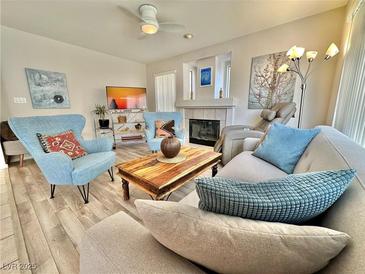 Cozy living room with comfortable seating, fireplace, and neutral tones at 10500 Horseshoe Falls Ct, Las Vegas, NV 89144