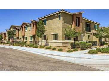 Inviting townhomes feature landscaped yards, neutral exteriors, and convenient walkways at 12282 Azure Gate Rd # 4, Las Vegas, NV 89183