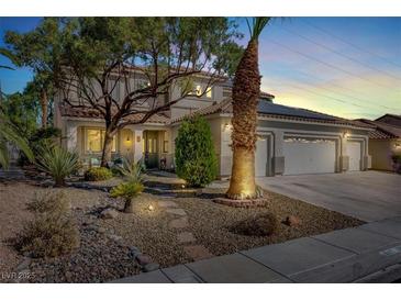 Charming two-story home featuring a three-car garage, desert landscaping, and mature trees creating curb appeal at 1306 Big Tree Ave, North Las Vegas, NV 89031