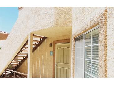Exterior shot of building with stair case leading to door and windows at 1851 Hillpointe Rd # 1711, Henderson, NV 89074