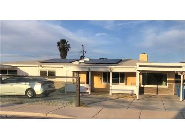 Charming single-story home featuring solar panels, covered porch, carport, and well-maintained front yard at 2217 Santa Ynez Dr, Las Vegas, NV 89104