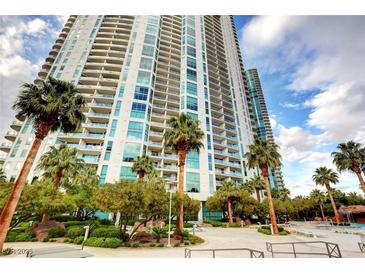A high-rise condominium building with lush landscaping, palm trees, and a resort-style pool, creating an inviting outdoor space at 222 Karen Ave # 2804, Las Vegas, NV 89109