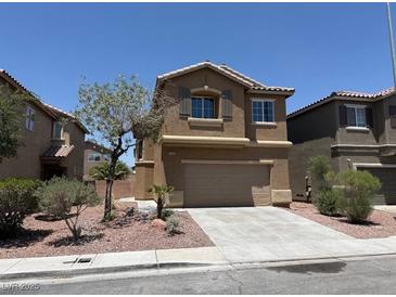 Attractive two-story home with a two-car garage, desert landscaping and tan stucco exterior at 3736 Gallowtree Ave, North Las Vegas, NV 89081