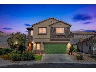 Charming two-story home featuring stone accents, a green garage door, and well-manicured landscaping at 4415 Peaceful Harbor St, Las Vegas, NV 89129