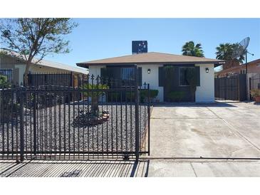 Charming single-story home featuring a secure black metal gate and low maintenance landscaping at 4509 Bingham Ave, Las Vegas, NV 89110