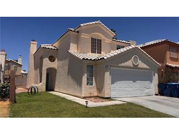 Charming two-story home featuring a tan stucco exterior, tile roof, and an attached two-car garage in a well-maintained neighborhood at 6058 Grape Blossom Ave, Las Vegas, NV 89142