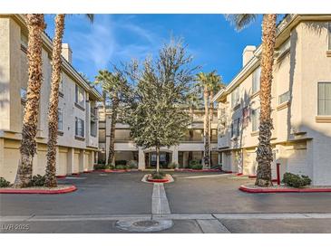 Inviting condo complex with lush landscaping, palm trees, and well-maintained buildings in a desirable location at 7127 S Durango Dr # 310, Las Vegas, NV 89113