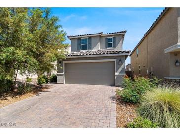 Charming two-story home with a brick driveway and attached two-car garage at 9730 Cluny Ave, Las Vegas, NV 89178
