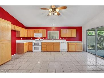 Bright kitchen featuring light wood cabinets and tiled floor at 1230 Pagentry Dr, North Las Vegas, NV 89031