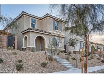 Inviting two-story home with stone accents, covered entry, and landscaped front yard in a desirable neighborhood at 1328 Graphite Ave, Henderson, NV 89002