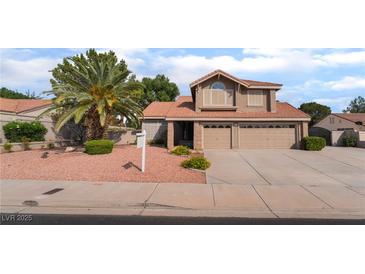 Two-story home featuring a terracotta roof, desert landscaping, and a two-car garage at 1587 Bermuda Dunes Dr, Boulder City, NV 89005