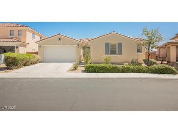 Charming single-story home featuring a two-car garage, desert landscaping, and a neutral color palette at 2008 Royal Gardens Pl, North Las Vegas, NV 89084