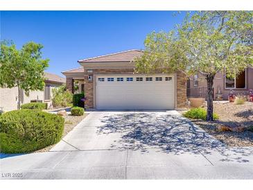 Charming single-story home with a two-car garage, desert landscaping, and a beautiful stone facade at 2616 Red Planet St, Henderson, NV 89044