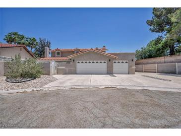 Charming two-story home featuring a spacious driveway and two-car garage under a bright blue sky at 3421 Rochelle Ct, Las Vegas, NV 89121