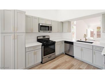 Bright kitchen features modern appliances, light gray cabinets, and white countertops at 3622 Covewick Dr, North Las Vegas, NV 89032