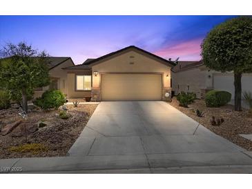 Charming single-story home with a well-maintained front yard and a two-car garage at 7817 Homing Pigeon St, North Las Vegas, NV 89084