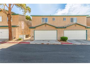 Two-story townhome featuring attached garages and desert landscaping for a low-maintenance appeal at 5249 Wave Dancer Ln, Las Vegas, NV 89118