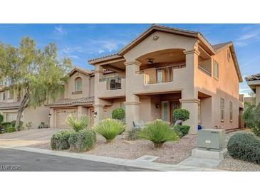 Charming two-story home featuring a balcony, well-manicured landscaping, and a two-car garage at 8093 Luna Sera Ave, Las Vegas, NV 89178