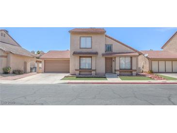 Inviting two-story home featuring a well-maintained lawn and attached two-car garage at 2711 Sesame Dr, Las Vegas, NV 89142