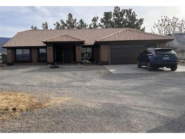 Charming single-story home with a well-maintained exterior and low-maintenance gravel landscaping at 3051 S Rainbow Ave, Pahrump, NV 89048