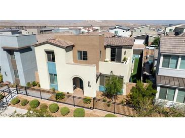 Exterior of a modern two-story home boasting a tiled roof, neutral color scheme, and manicured landscaping at 3369 Ponicelli Ln, Henderson, NV 89044