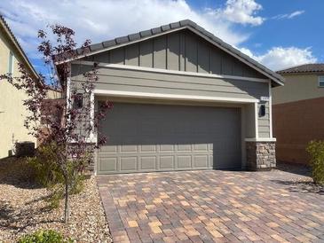 Home exterior with a two car garage and a brick driveway at 3447 Sw Covilha Ln, Henderson, NV 89044