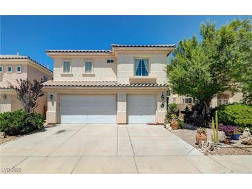 Two-story home featuring a tile roof and a two-car garage, with desert landscaping at 3873 Palm Island Ct, Las Vegas, NV 89147