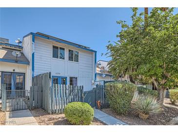Charming two-story townhome with a quaint fenced yard and mature landscaping at 4259 Kona Coast Way, Las Vegas, NV 89121