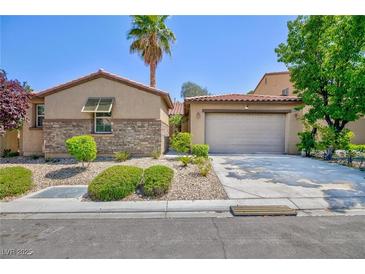 Charming single-story home with a two-car garage, neutral paint, desert landscaping, and a red tile roof at 7609 Slide Rock Ave, Las Vegas, NV 89113