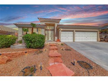 Charming home with desert landscaping, tiled roof and dramatic sunset sky at 1126 Winter Storm Dr, Henderson, NV 89052