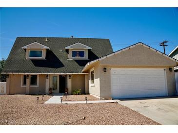 Charming single-story home with a two-car garage, beautiful front yard, and meticulous landscaping at 2659 Vegas Valley Dr, Las Vegas, NV 89121
