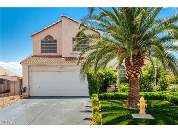 Charming two-story home featuring a well-maintained front yard and a mature palm tree at 3825 Manhattan Bridge Pl, North Las Vegas, NV 89032