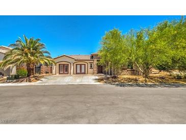 Charming single-story home featuring desert landscaping, a tile roof, and double door entry at 5396 Splendido Ave, Pahrump, NV 89061