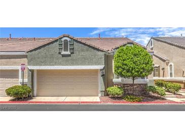Charming townhouse featuring a two-car garage and well-maintained landscaping at 979 Coatbridge St, Las Vegas, NV 89145