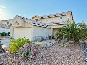 Charming front exterior showcasing desert landscaping, palm trees and a two-car garage, with a charming entry at 1068 African Eagle Ave, Henderson, NV 89015