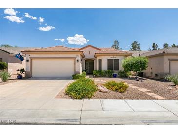 Charming single-story home featuring a xeriscaped front yard and two-car garage at 2111 Tiger Links Dr, Henderson, NV 89012