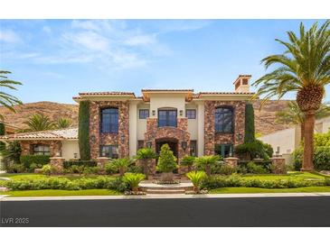 Stunning stone and stucco home with lush landscaping and a grand entrance at 2793 Red Arrow Dr, Las Vegas, NV 89135